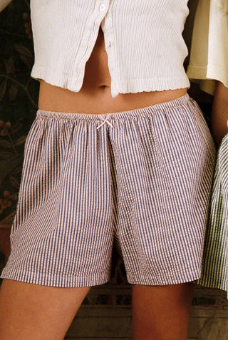 Woman wearing cotton pink and grey striped sleep shorts