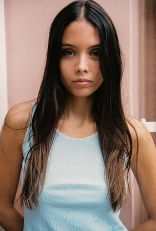 Woman wearing light blue pointelle tank top