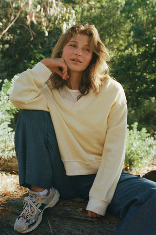 Woman wearing soft yellow sweatshirt