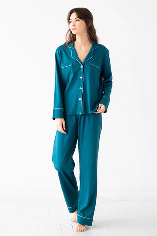 Woman wearing Salua Lingerie teal pima cotton pajamas with white piping