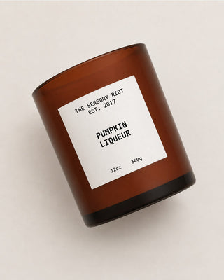 Sensory Riot's Pumpkin Liqueur Candle with white label and brown glass container