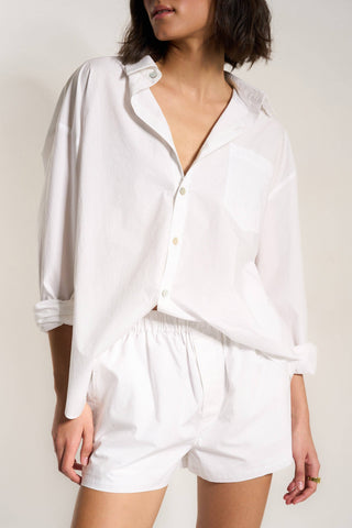 Lightweight white women's lounge shorts shown with matching button up top