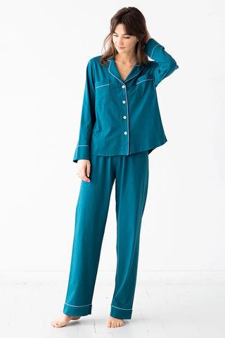 Women wearing Salua classic pima cotton teal pajama set with long sleeve top and pants