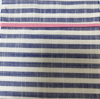 Close up of blue and white striped sleep shirt with pink trim