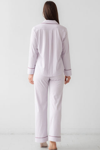Back profile of purple sleepwear with contrast piping