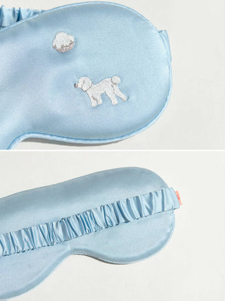 Close up of silk soft sky blue eye mask with dog pattern