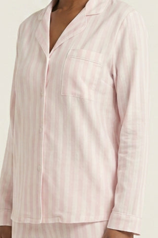 Woman wearing Stripe & Stare pink & white stripe long PJ set.