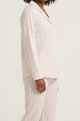 Woman wearing Stripe & Stare pink & white stripe long PJ set.