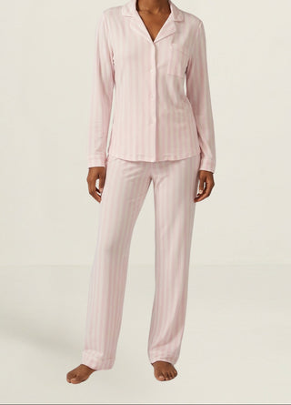 Woman wearing Stripe & Stare pink & white stripe long PJ set.