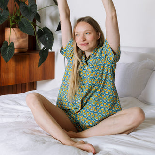 Woman wearing Block Shop organic cotton short PJ set set in marigold pattern