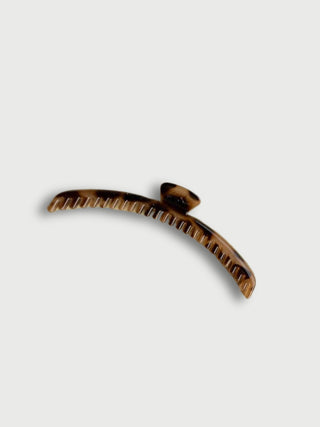 Tortoiseshell hair claw clip on a white background
